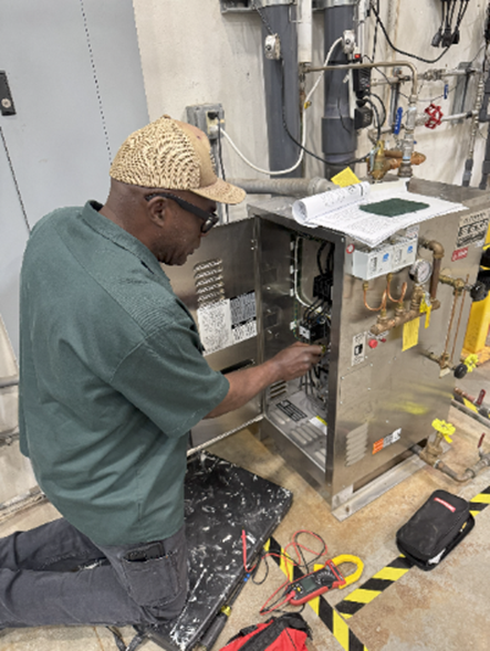 A BIMS technician working on equipment in Dallas